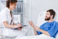 Hospital patient talking with nurse