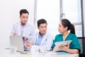 Hospital, profession, people and medicine concept - group of happy doctors with tablet pc computers meeting at medical office Royalty Free Stock Photo