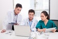 Hospital, profession, people and medicine concept - group of happy doctors with tablet pc computers meeting at medical office Royalty Free Stock Photo