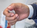 In a hospital room, a patient conscientiously utilizes the emergency nurse call button device Royalty Free Stock Photo