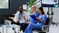 Hospital staff consulting patient