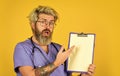 Hospital treatment. Man bearded doctor with folder. Seek urgent medical attention. Evidence based medicine. Coronavirus Royalty Free Stock Photo