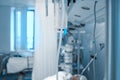 Hospital ward with life support equipment connected to the comatose patient, tube in the center of image as a concept of binding