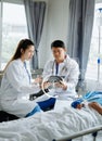 Hospital Ward Male and Female Professional Caucasian Doctors Talk with a Patient, Give Health Care Advice, Recommend Treatment Royalty Free Stock Photo