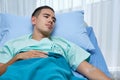 Young Cacausian male Patient Lying on Bed Royalty Free Stock Photo