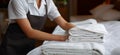 Hospitality finesse Maid carefully arranges towel, perfecting the hotel room