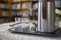 A hospitality tray with a silver thermos and small patterned coffee cups set Royalty Free Stock Photo