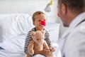 Hospitalized child in clown therapy with doctor Royalty Free Stock Photo