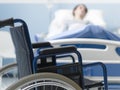 Hospitalized patient lying in bed and wheelchair Royalty Free Stock Photo