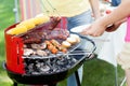 Host serving woman grilled sausage