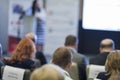 Host Speaker Standing on Stage in Front of the Audience at the Conference. Royalty Free Stock Photo