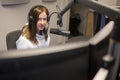 Host Wearing Headphones While Using Microphone In Radio Studio Royalty Free Stock Photo