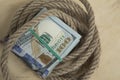 Hostage buyout concept image. Money dollars and rope
