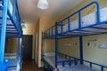 Hostel dormitory beds arranged in dorm room Royalty Free Stock Photo