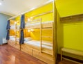 Hostel dormitory beds arranged in room Royalty Free Stock Photo