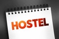 Hostel - low-cost, short-term shared sociable lodging where guests can rent a bed, text on notepad, concept background