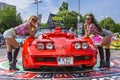 Hostess posing near Corvette car