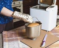 Hostess takes fresh bread from an electric bread machine Royalty Free Stock Photo