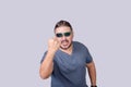 A hostile and irate man threatens to hit someone with his fist. Isolated on a gray background Royalty Free Stock Photo