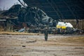 Ukrainian soldier is walking in the background of ukrainian Mriya AN-225 destroyed on Hostomel airfield