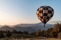 Hot air balloon flying in the mountains Royalty Free Stock Photo
