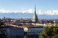A hot-air ballon flying near the Mole, in a Turin panorama with the alps in background. Royalty Free Stock Photo