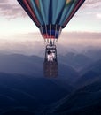 Hot air balloon above mountains