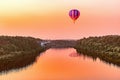 Hot air balloon above the river.