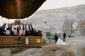 Hot air balloon basket with tourist flying near a wedding couple Royalty Free Stock Photo