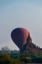 Hot air balloon behind temple in Bagan