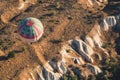 Hot air balloon with blue and red colors pattern rising over the Cappadocian valley