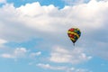 Hot air balloon in the blue sky clouds background to destination leisure travel. Royalty Free Stock Photo