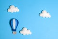 Hot air balloon in blue sky with clouds, frame, copyspace. Hand made felt toys. Royalty Free Stock Photo