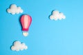 Hot air balloon in blue sky with clouds, frame, copyspace. Hand made felt toys. Royalty Free Stock Photo