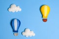 Hot air balloon in blue sky with clouds, frame, copyspace. Hand made felt toys. Royalty Free Stock Photo