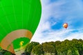 Hot air balloon with burner and fire before starting, another ballon in the sky Royalty Free Stock Photo