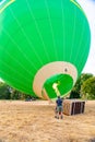 Hot air balloon with burner and fire before starting. Blowing up the balloon. Royalty Free Stock Photo