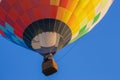 Hot air balloon in clear blue sky. Colorful balloon with basket lift up. Summer adventure and leisure. Aviation sport concept.