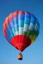 Hot air balloon, colorful aerostat with people, blue sky