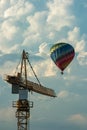 Hot air balloon with construction site crane in the front plane