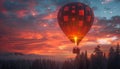 Hot air balloon drifting over sunset forest in sky