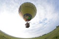 Hot-air balloon drifting under the ground in the field