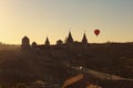 Hot air balloon flies near Kamianets-Podilskyi castle. It is famous touristic place and romantic travel destination.