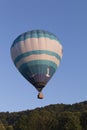 Hot air balloon in flight over mountains Royalty Free Stock Photo