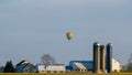 Hot air balloon floating above an Amish farm house, Lancaster County, PA Royalty Free Stock Photo