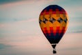Hot air balloon floating by during a beautiful sunset during an airshow