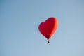 Hot air balloon floating in the sky big red hot air balloon in the shape of a big heart for love and world peace Royalty Free Stock Photo
