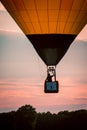 Hot air balloon floating by at sunset during an airshow