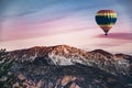 Hot air balloon flying against a snowed mountains in the Pyrenees in a adventure sports tourism activiry. Nature landscape