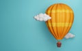 Hot air balloon flying among the clouds and carrying a gift box with blue background and copy space Royalty Free Stock Photo